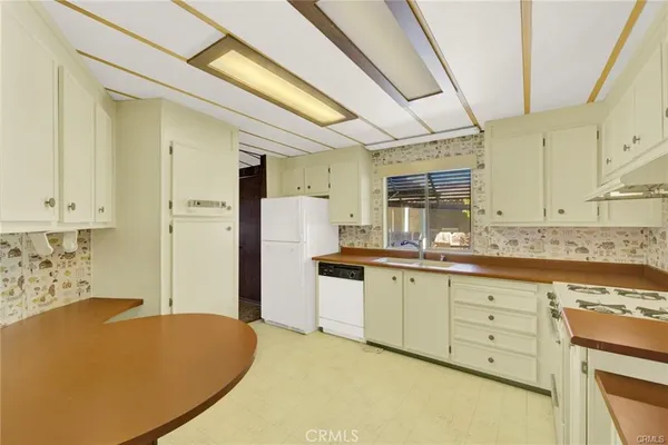a kitchen with stainless steel appliances cabinets and stove