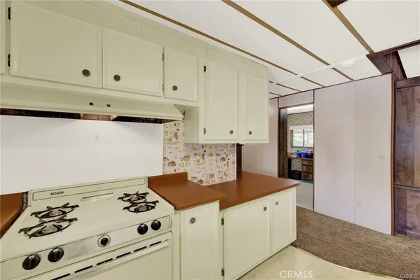 a view of a hallway with wooden floor and a window