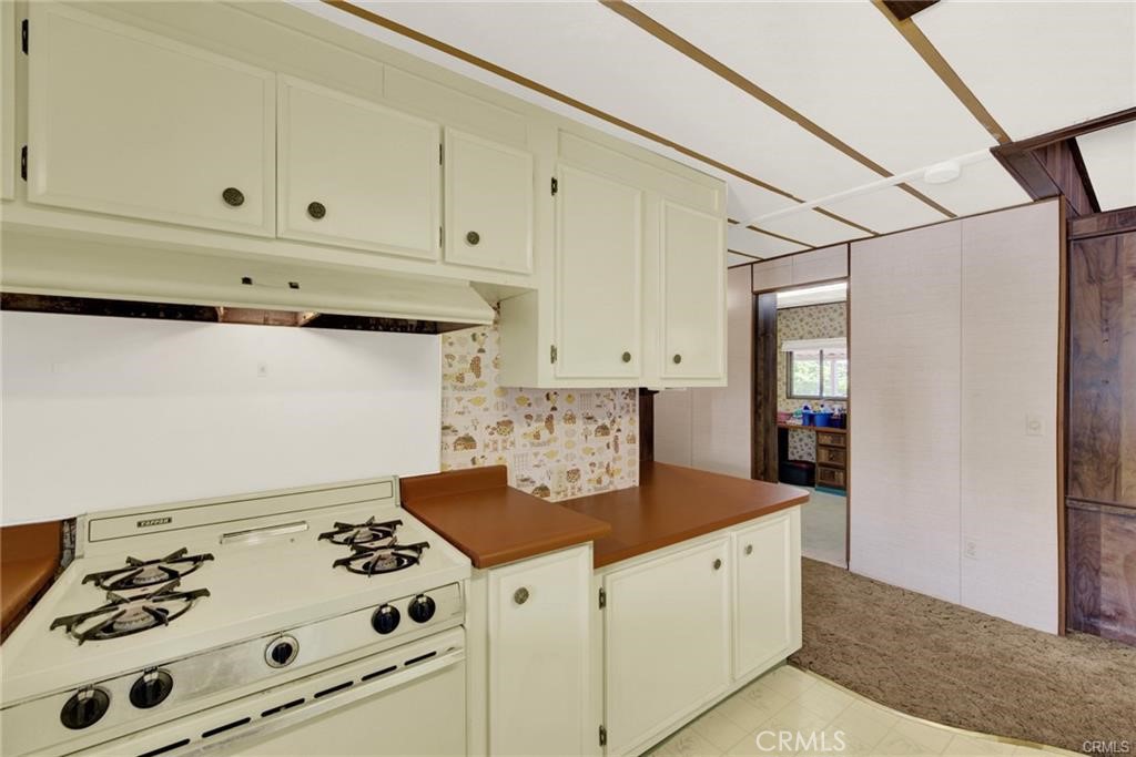 3835 Gardiner Ferry Road, Unit 3 Corning, CA 96021 - Photo 16 of 20 a kitchen with stainless steel appliances cabinets and stove