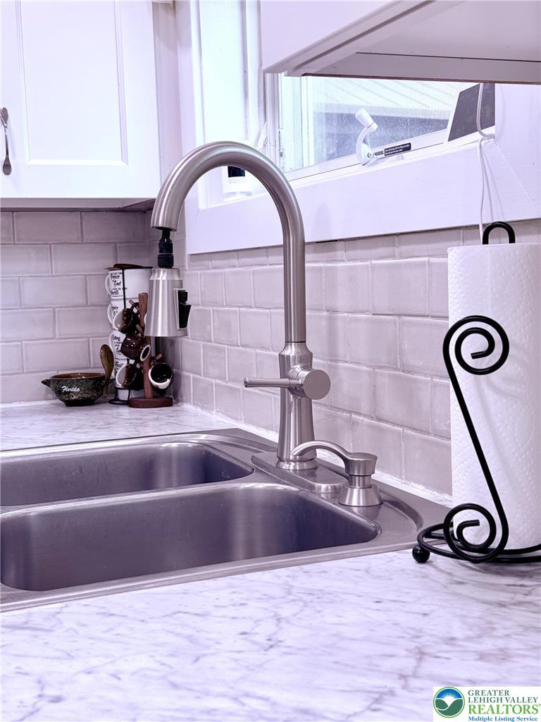 1275 Macada Road Bethlehem, PA 18017 - Photo 34 of 87 A sleek kitchen sink with modern faucet, set against a subway tile backsplash, awaits culinary adventures.