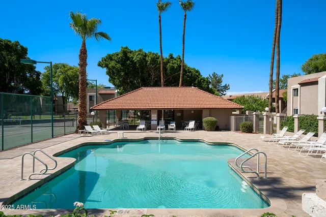 a view of a house with swimming pool and sitting area