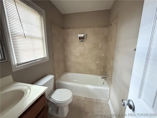 a bathroom with a toilet and a bath tub