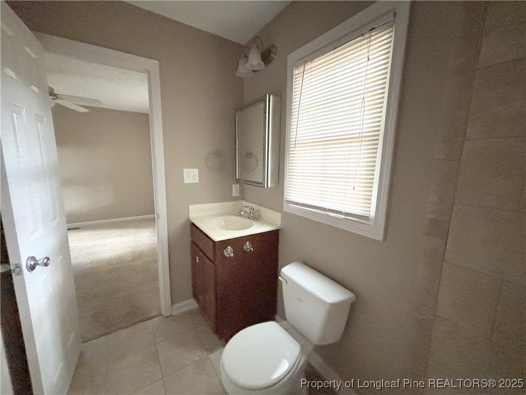 229 Lansdowne Road Fayetteville, NC 28314 - Photo 18 of 18 a bathroom with a toilet sink vanity and mirror