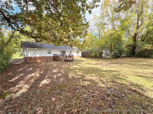 a view of a house with a yard and sitting area