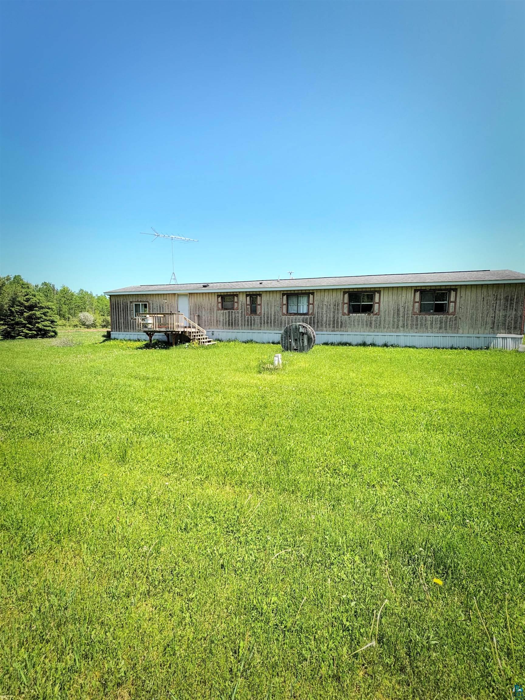 67805 Old County Road High Bridge, WI 54846 - Photo 10 of 11 Manufactured home featuring wood-look siding and multiple windows