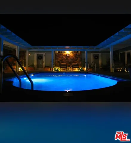 a view of swimming pool with seating space