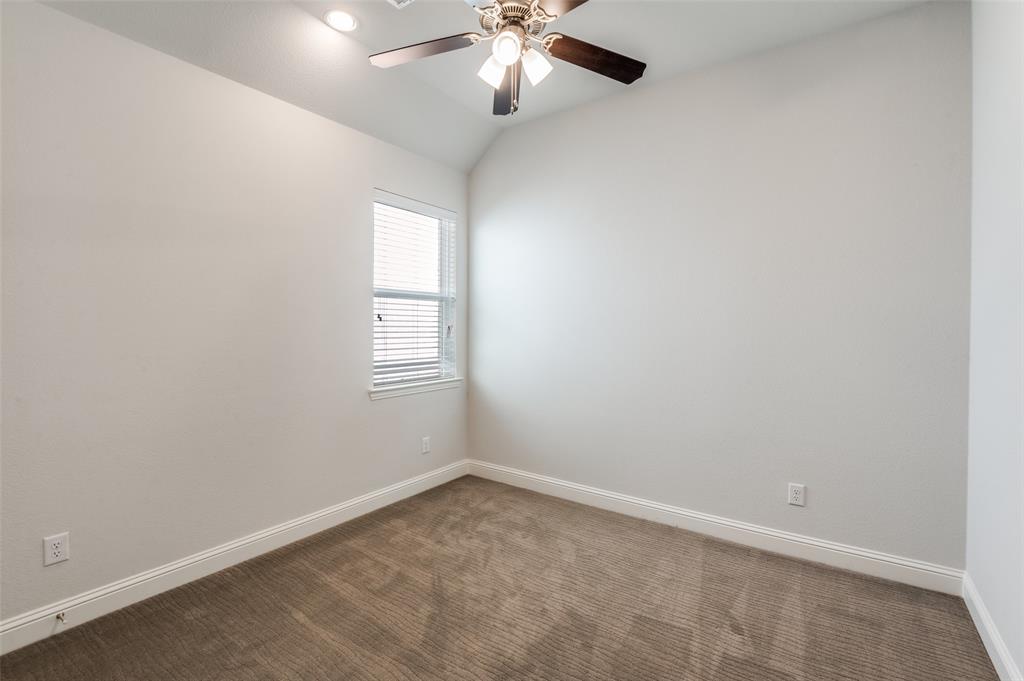 15621 Fringe Tree Road Frisco, TX 75035 - Photo 12 of 18 Unfurnished room featuring carpet floors, vaulted ceiling, and ceiling fan