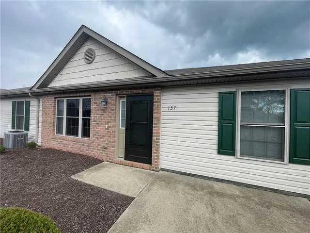 a front view of a house with a large window