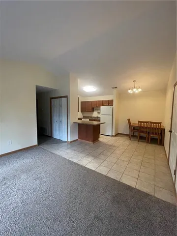 a kitchen with a refrigerator sink stove and cabinets
