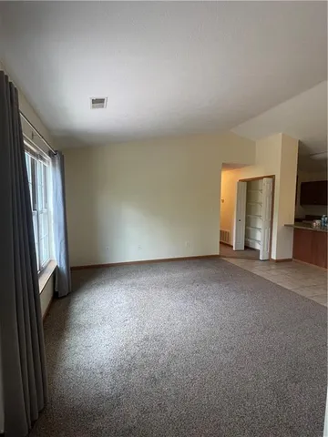 a view of kitchen with furniture and refrigerator