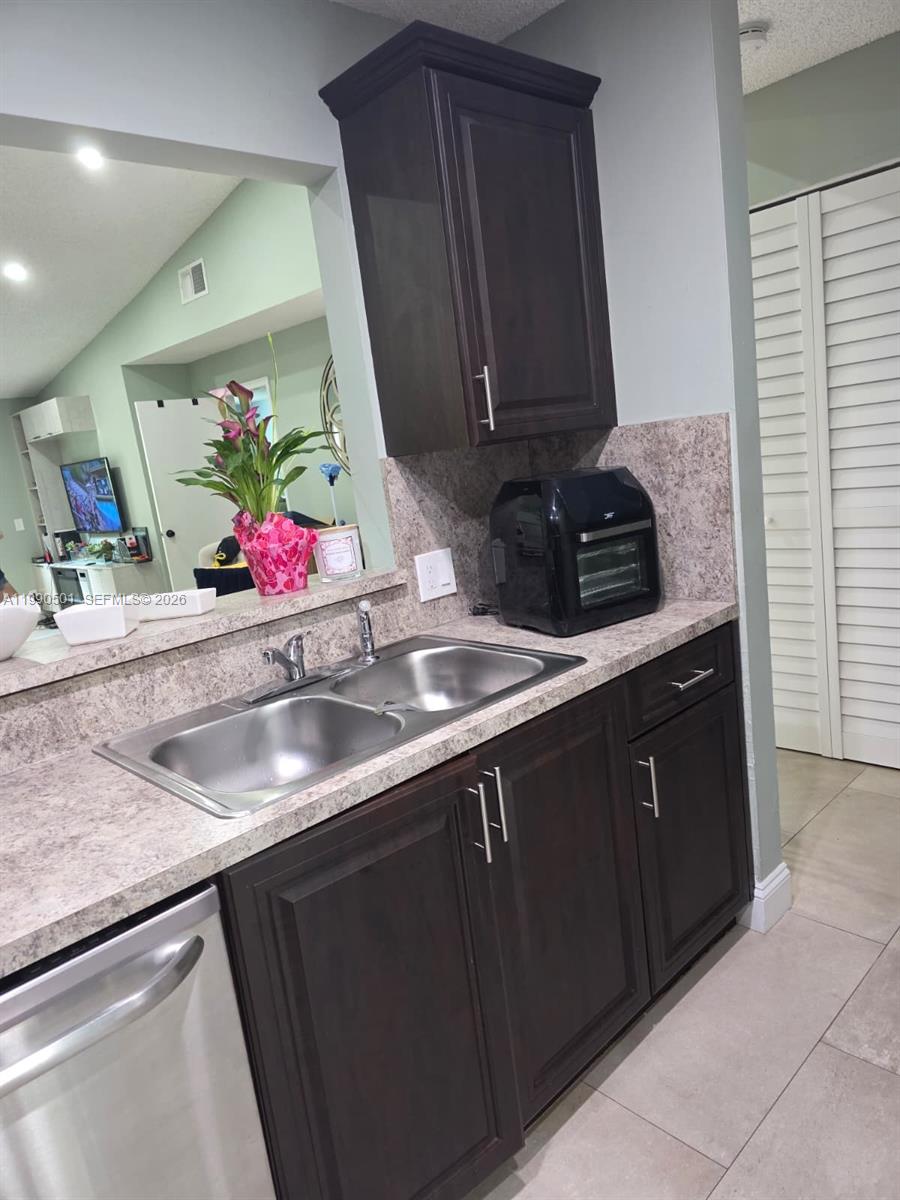 893 Southwest 120th Way Davie, FL 33325 - Photo 4 of 22 a kitchen with a sink and cabinets