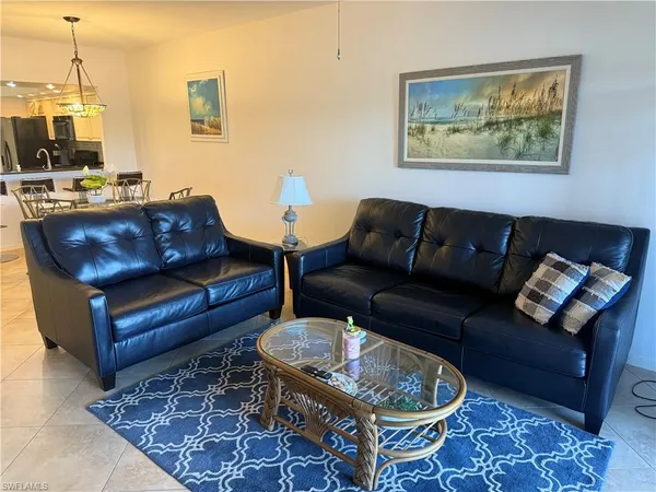 a living room with furniture and a rug