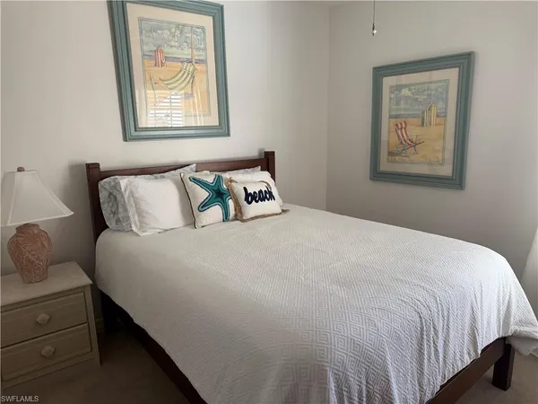 a bedroom with bed and window