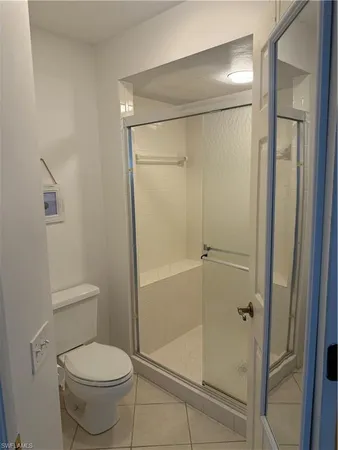 a bathroom with a shower a toilet and a sink