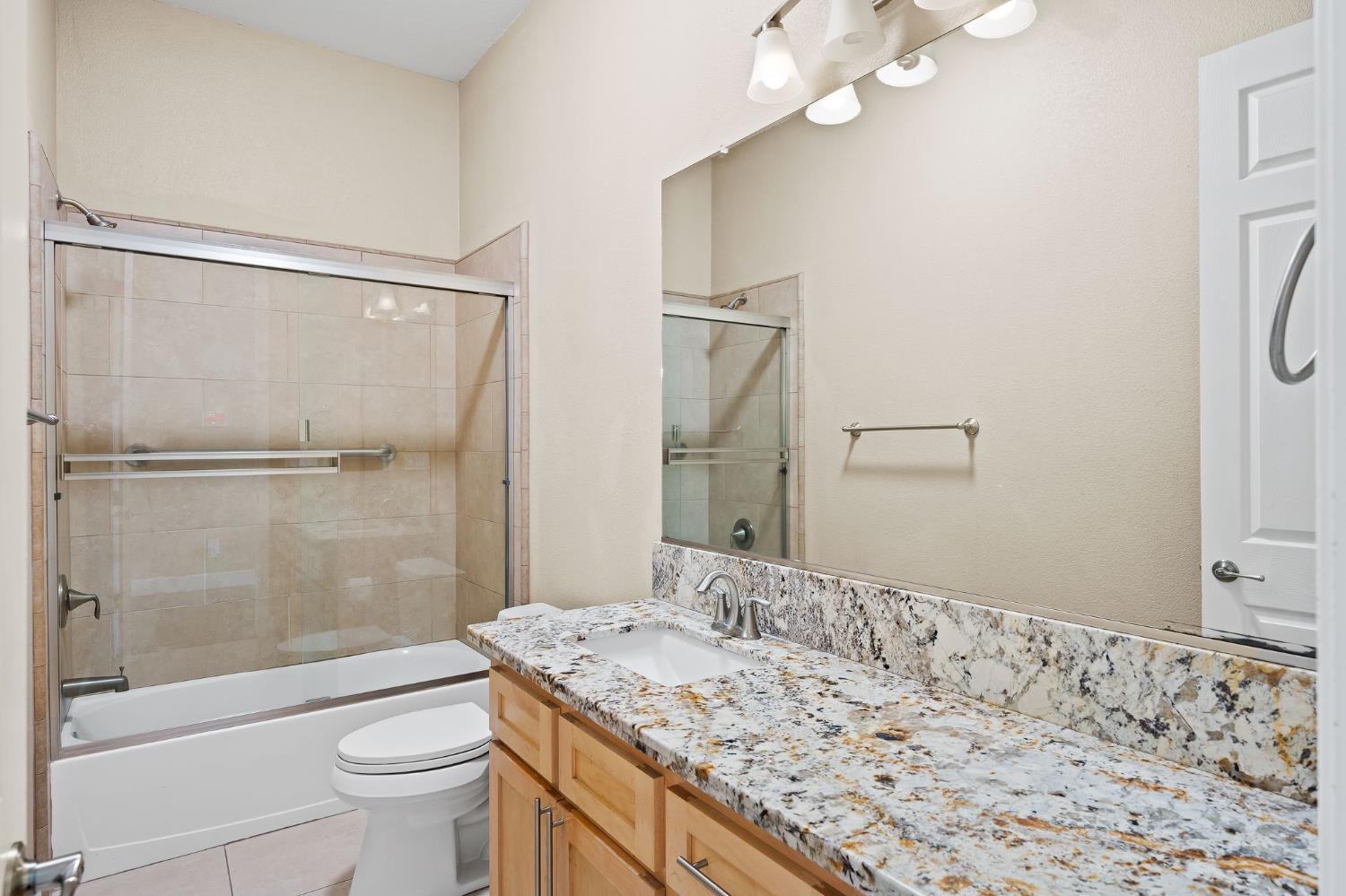 209 Fall Avenue Patterson, CA 95363 - Photo 11 of 48 a bathroom with a sink and a mirror