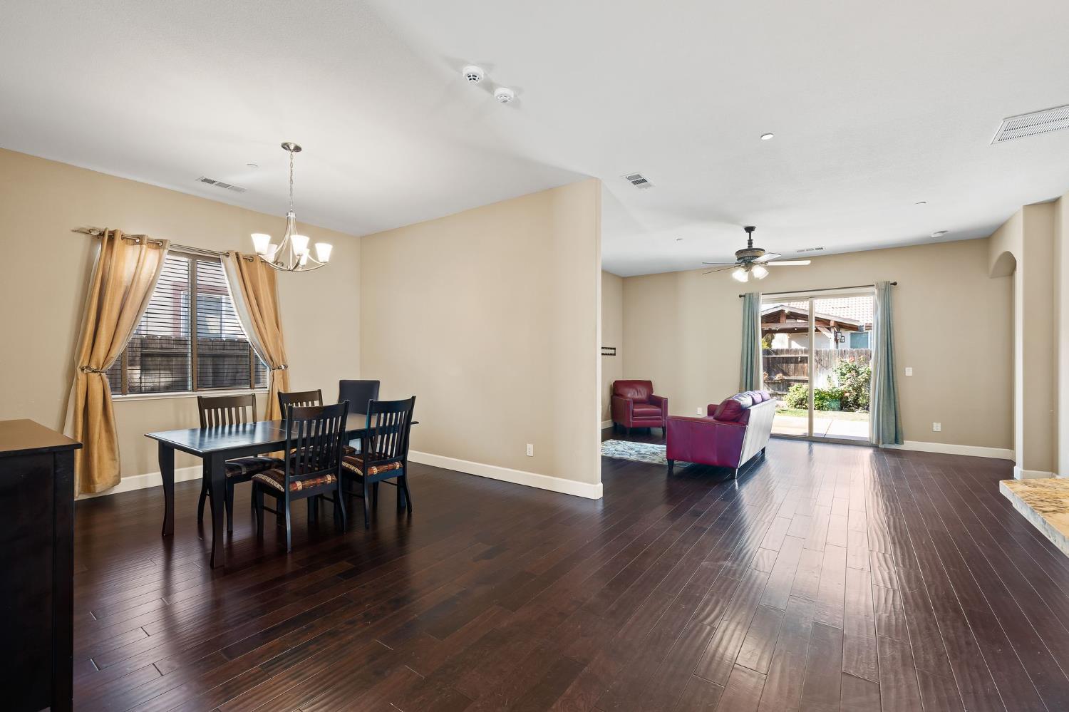 209 Fall Avenue Patterson, CA 95363 - Photo 12 of 48 a view of a dining room with furniture and wooden floor