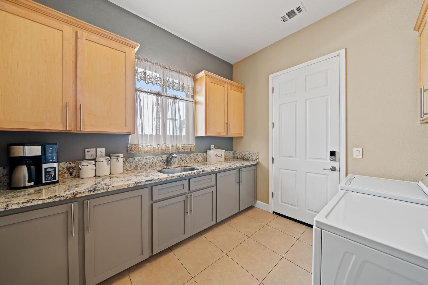 209 Fall Avenue Patterson, CA 95363 - Photo 17 of 48 a kitchen with a sink and cabinets