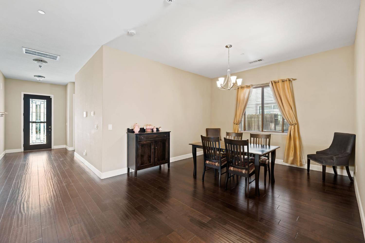 209 Fall Avenue Patterson, CA 95363 - Photo 19 of 48 a view of a dining room with furniture window and wooden floor
