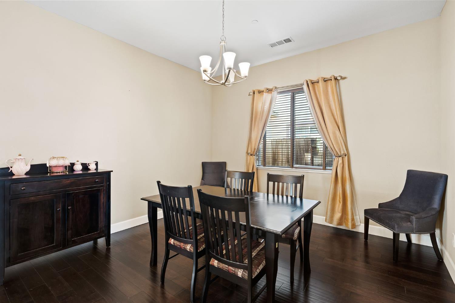 209 Fall Avenue Patterson, CA 95363 - Photo 20 of 48 a view of a dining room with furniture and wooden floor