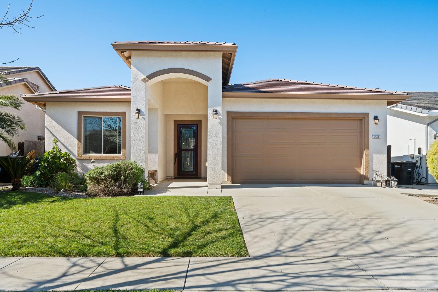 209 Fall Avenue Patterson, CA 95363 - Photo 2 of 48 a front view of a house with garden