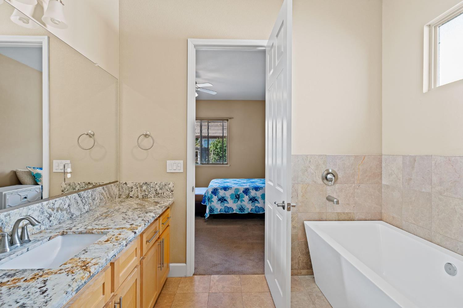 209 Fall Avenue Patterson, CA 95363 - Photo 31 of 48 a spacious bathroom with a tub sink and mirror