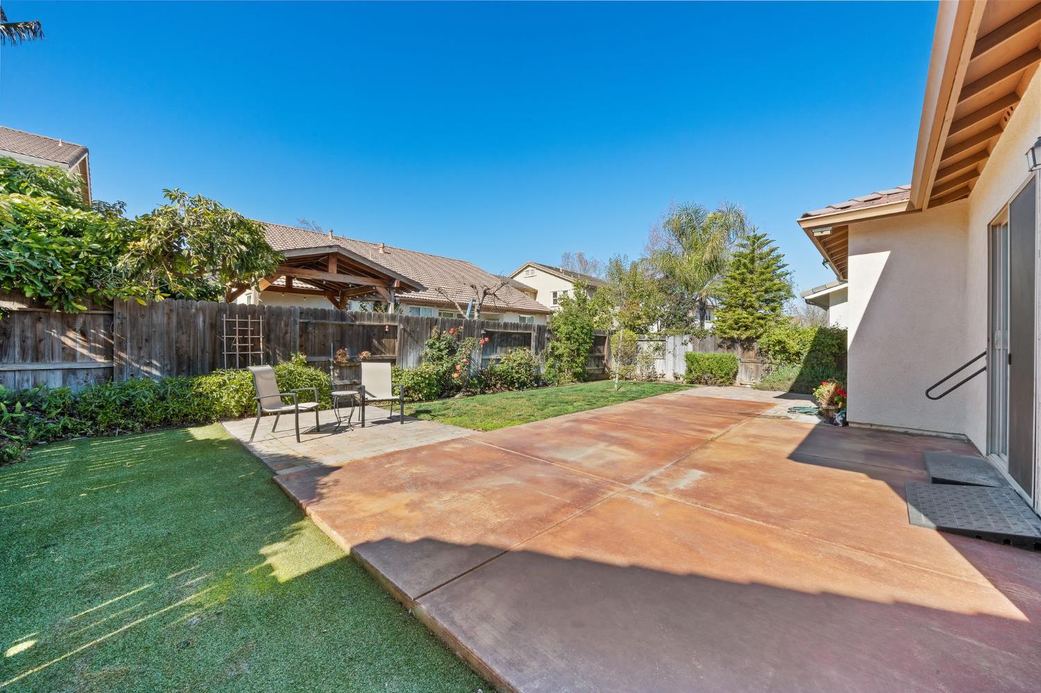 209 Fall Avenue Patterson, CA 95363 - Photo 33 of 48 a view of a backyard with a garden and chair