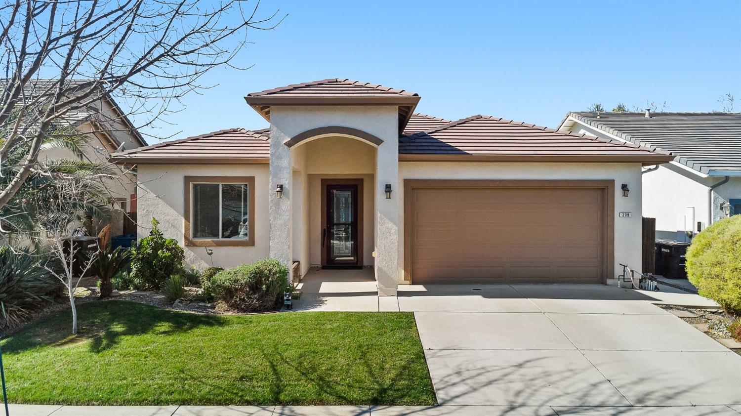209 Fall Avenue Patterson, CA 95363 - Photo 37 of 48 a front view of a house with a yard and garage