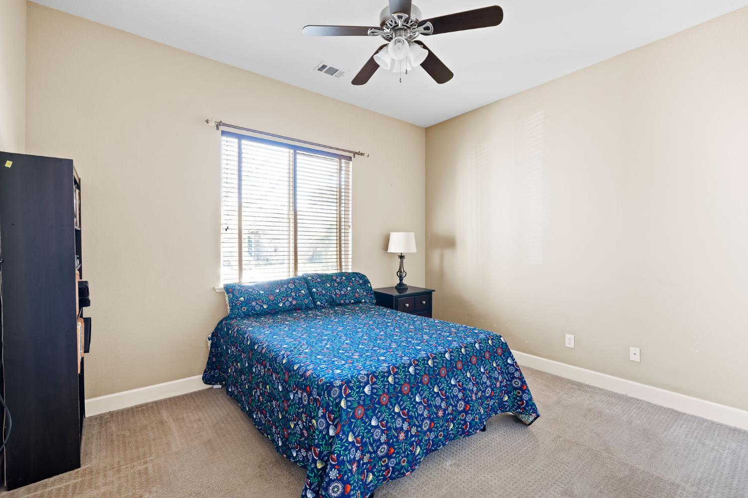 209 Fall Avenue Patterson, CA 95363 - Photo 7 of 48 a bedroom with a bed and window