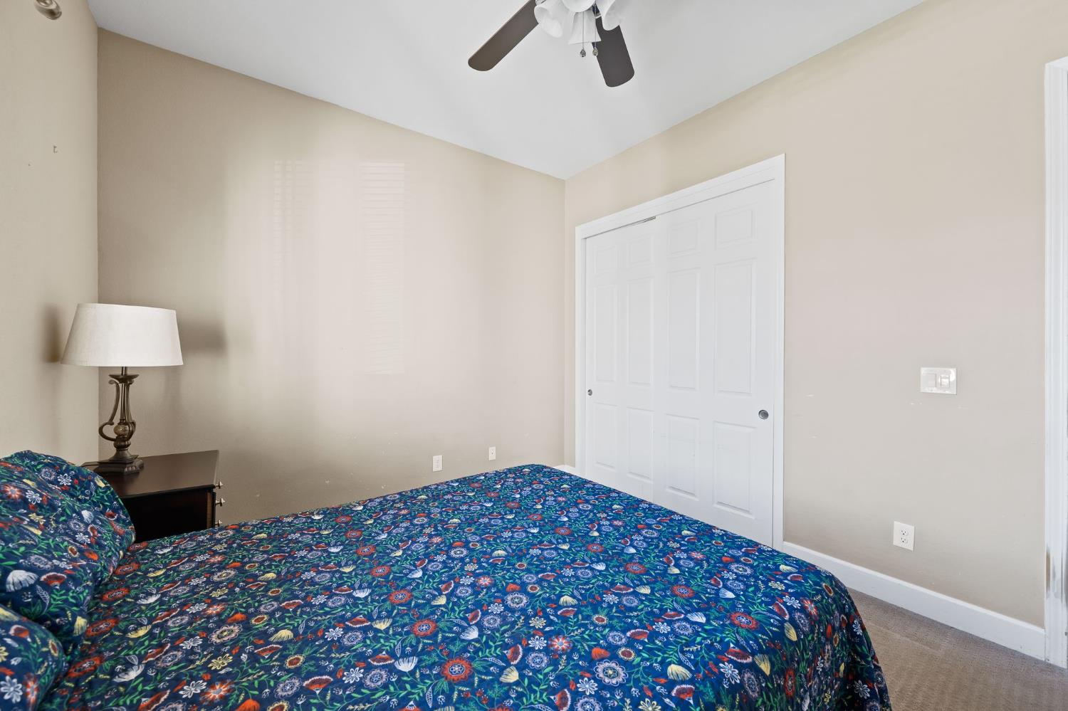 209 Fall Avenue Patterson, CA 95363 - Photo 8 of 48 a bedroom with a bed and a lamp on the dresser