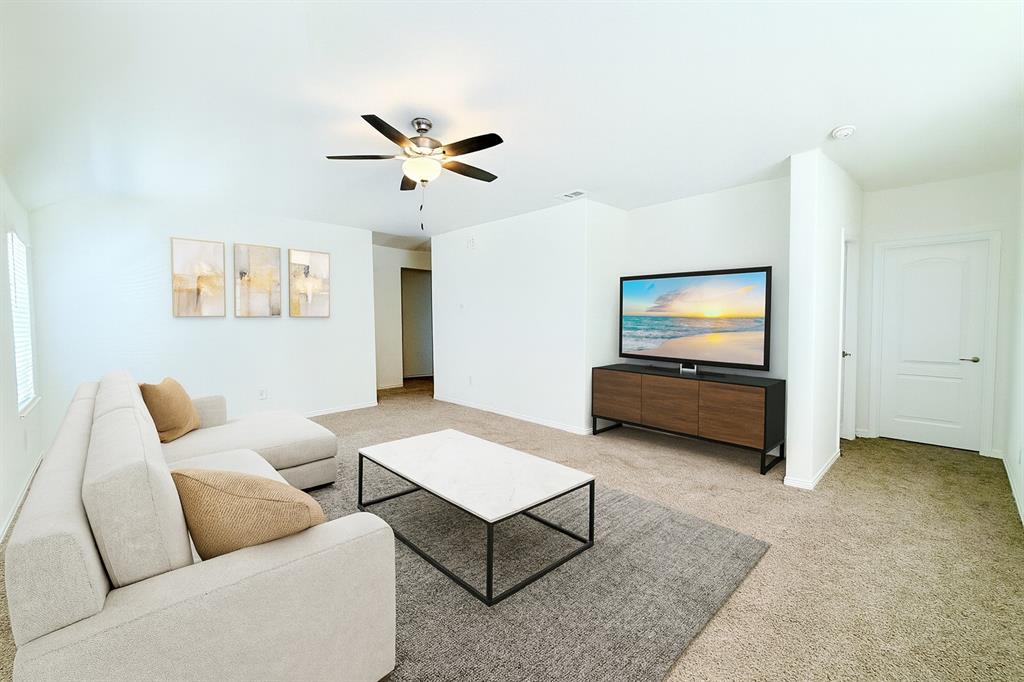 1336 Morning View Road Georgetown, TX 78628 - Photo 25 of 40 A comfortable living space featuring soft carpet and a convenient ceiling fan.