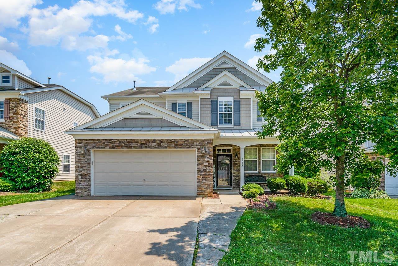 4024 Oatgrass Lane Raleigh, NC 27604 - Photo 1 of 10 a front view of a house with a yard and garage