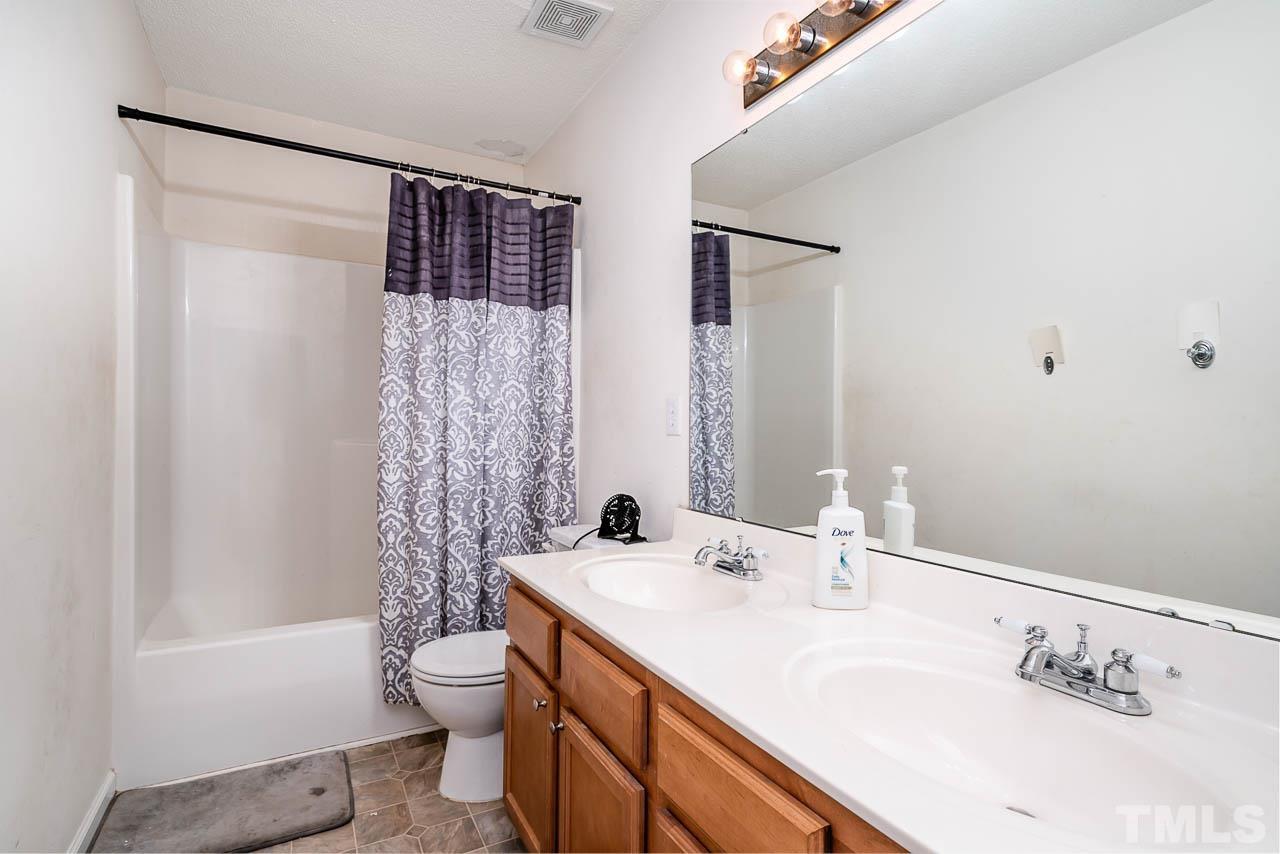 4024 Oatgrass Lane Raleigh, NC 27604 - Photo 6 of 10 a bathroom with a double vanity sink toilet and shower