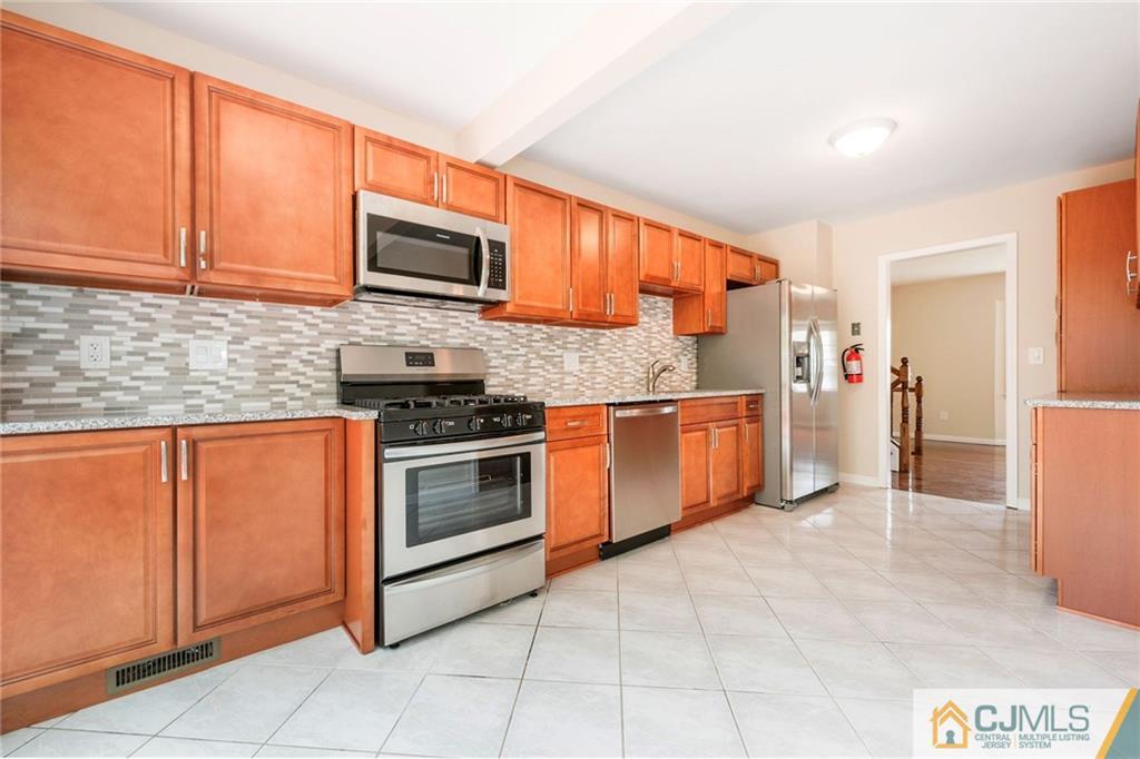 13 Barton Road Old Bridge, NJ 08857 - Photo 2 of 24 a kitchen with stainless steel appliances granite countertop a stove top oven a sink and dishwasher