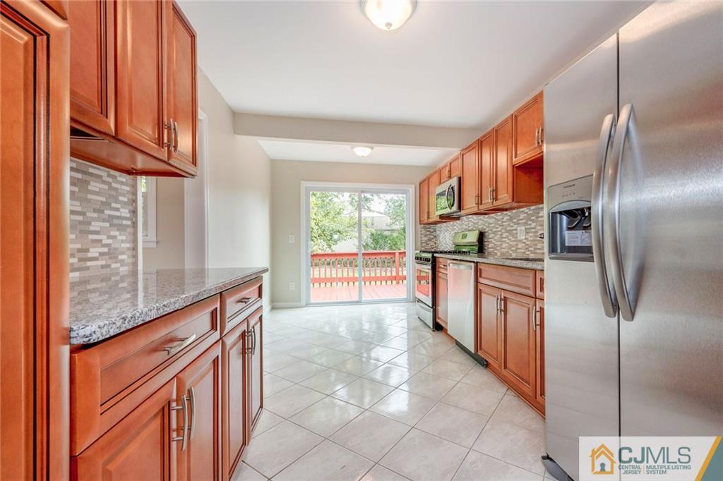 13 Barton Road Old Bridge, NJ 08857 - Photo 13 of 24 a kitchen with stainless steel appliances granite countertop a refrigerator and a stove