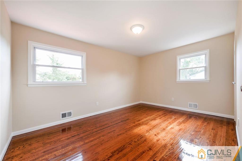 13 Barton Road Old Bridge, NJ 08857 - Photo 14 of 24 a view of an empty room with wooden floor and a window