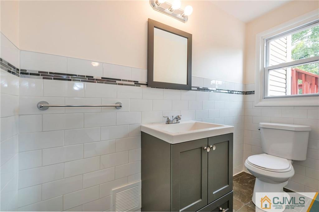 13 Barton Road Old Bridge, NJ 08857 - Photo 20 of 24 a bathroom with a toilet a sink and a window