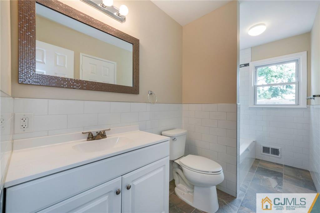13 Barton Road Old Bridge, NJ 08857 - Photo 21 of 24 a bathroom with a toilet a sink and mirror
