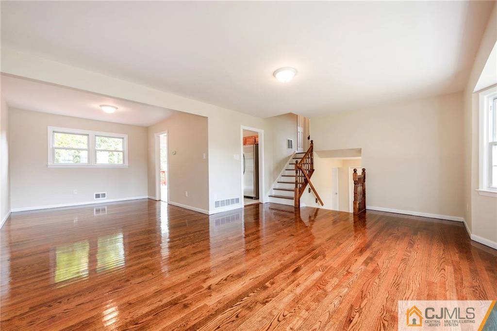 13 Barton Road Old Bridge, NJ 08857 - Photo 8 of 24 a view of empty room with wooden floor and fan
