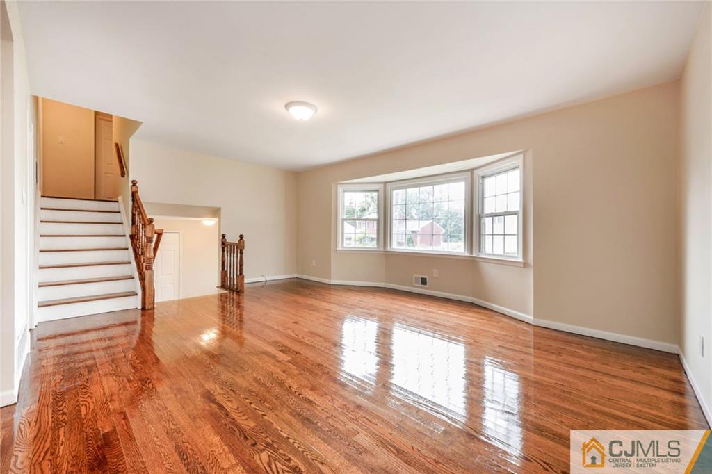 13 Barton Road Old Bridge, NJ 08857 - Photo 10 of 24 a view of an empty room with a window and wooden floor