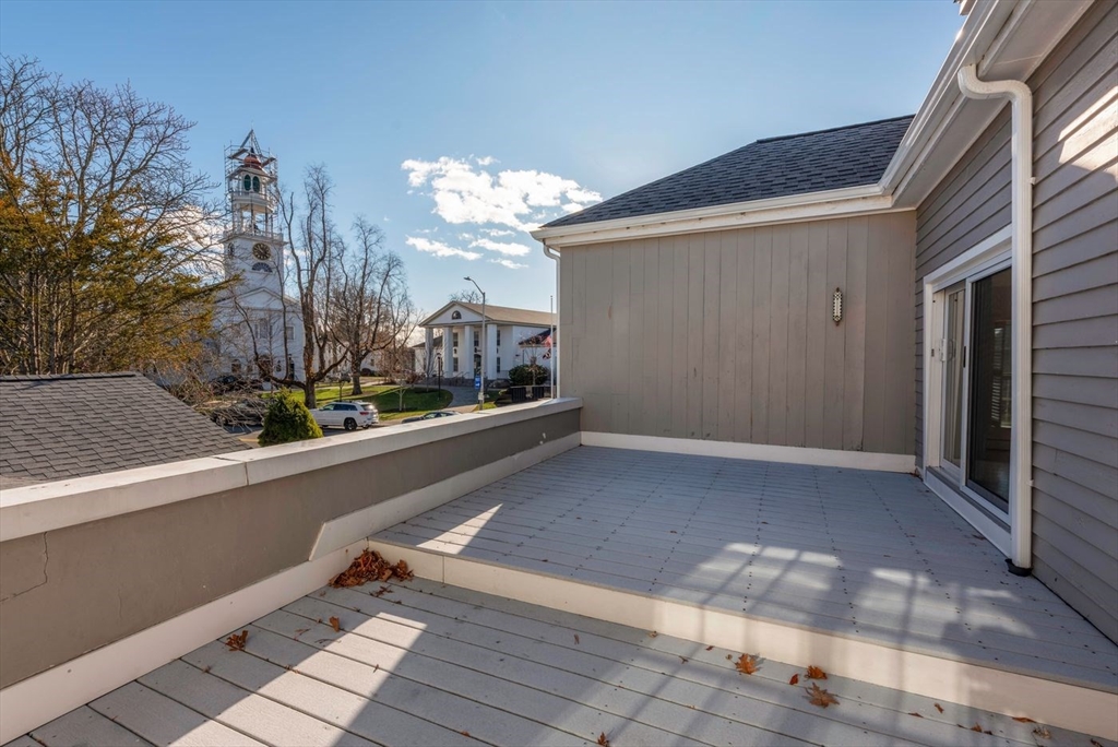 21 Central Street, Unit 1 Manchester, MA 01944 - Photo 13 of 24 a view of a house with a porch and wooden floor