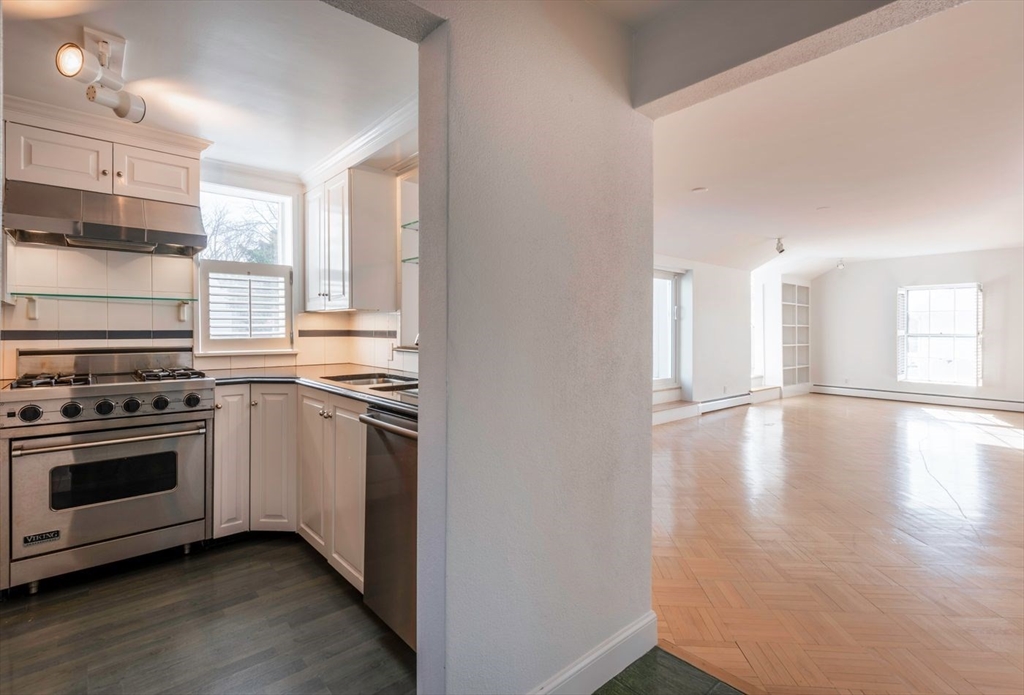 21 Central Street, Unit 1 Manchester, MA 01944 - Photo 14 of 24 a kitchen with a stove a sink and a refrigerator