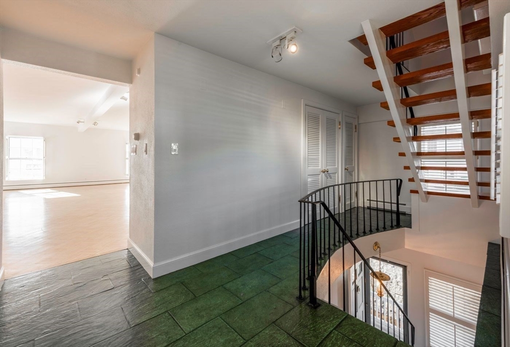 21 Central Street, Unit 1 Manchester, MA 01944 - Photo 16 of 24 a view of a hallway with wooden floor and windows