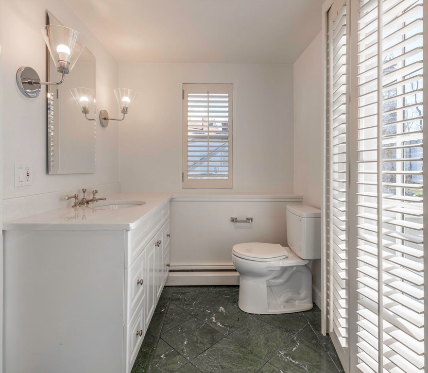 21 Central Street, Unit 1 Manchester, MA 01944 - Photo 18 of 24 a bathroom with a double vanity sink toilet and a tub
