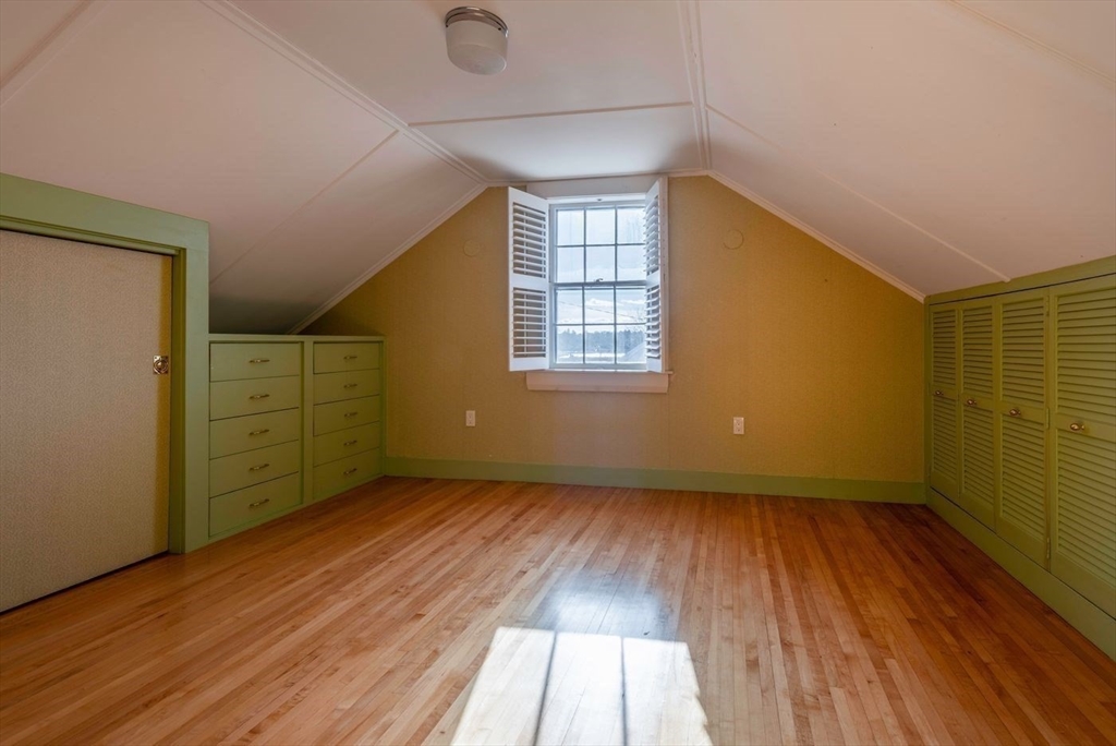 21 Central Street, Unit 1 Manchester, MA 01944 - Photo 20 of 24 an empty room with wooden floor and windows