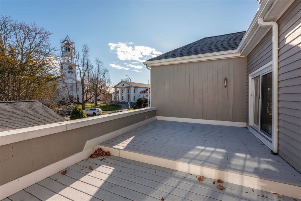 21 Central Street, Unit 1 Manchester, MA 01944 - Photo 10 of 24 a view of a house with a porch and wooden floor