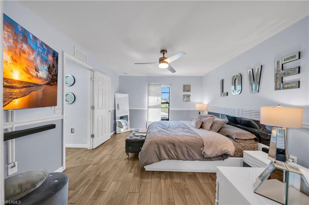175 Shadowview Court Lehigh Acres, FL 33974 - Photo 21 of 39 Bedroom featuring light wood-style floors and ceiling fan