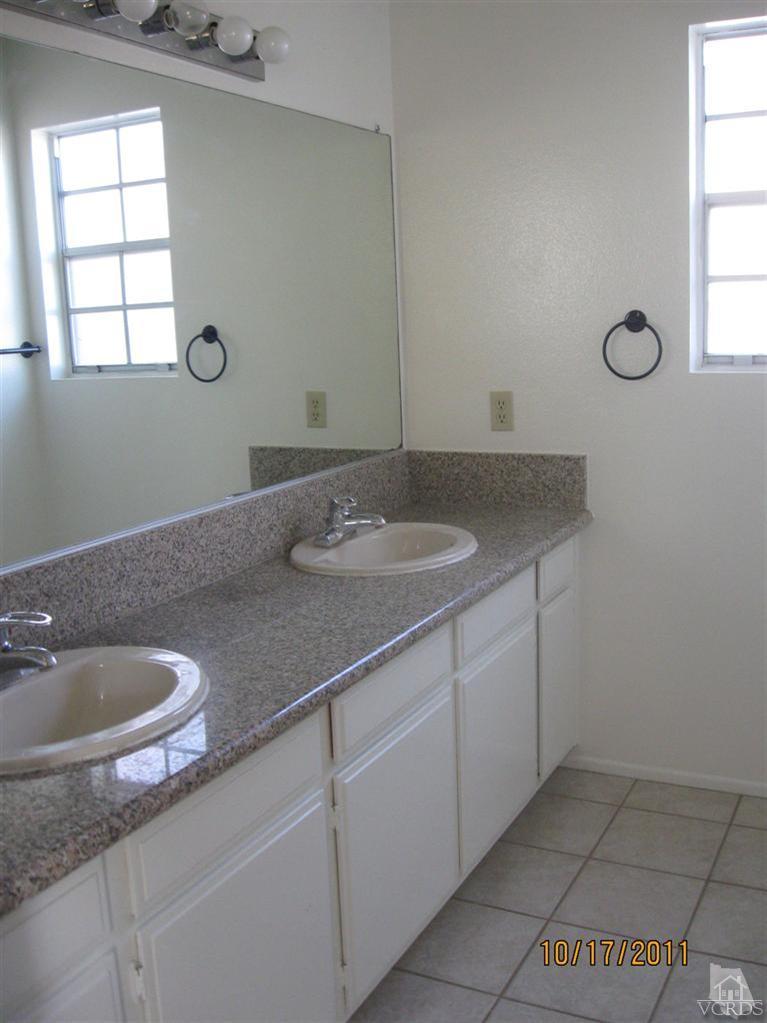 1151 Rivas Lane Oxnard, CA 93035 - Photo 6 of 11 a bathroom with a granite countertop sink and mirror