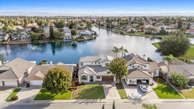 an aerial view of a house with a lake view