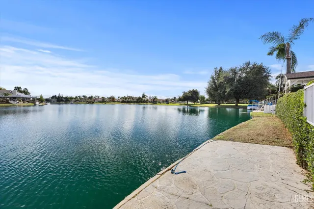 a view of a lake with houses in the back