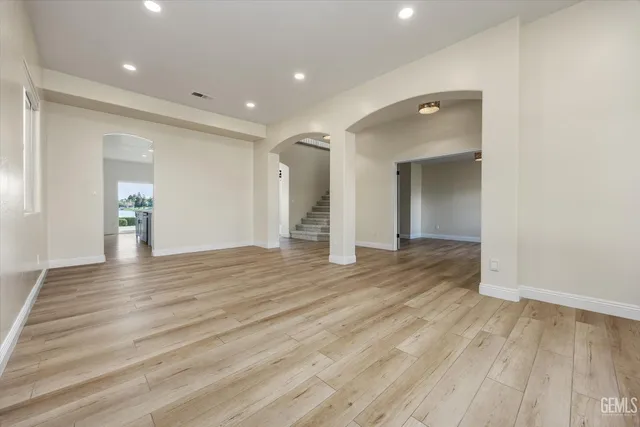 an empty room with closet and windows